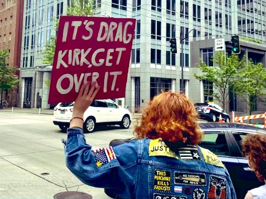 I love the person with the sign that says, “It’s drag Kirk,
get over it.” Indicating it’s harmless, no big deal. Yet a closer look at her jacket reveals death threats and their true violent leanings - “this machine kills.” Oh, and the Satanist goat. Nothing to worry about here.