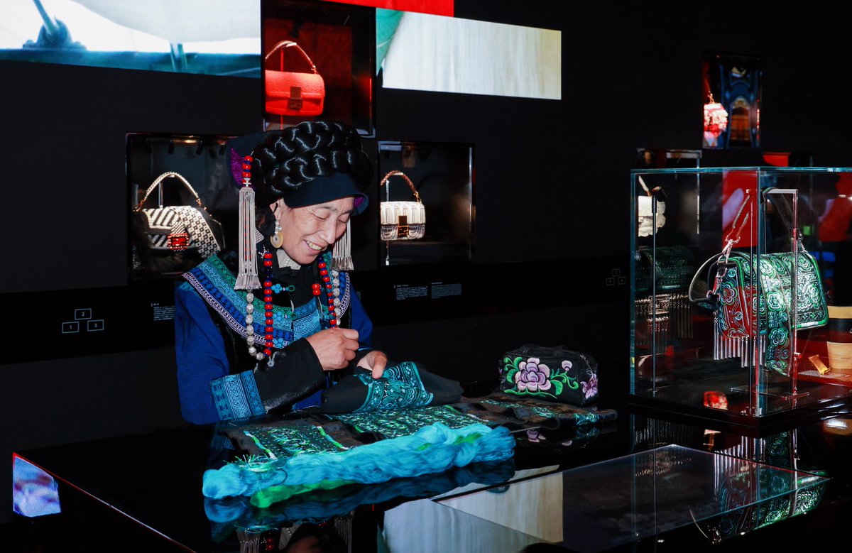 Fendi's tweet photo. Through 16/6, Fendi hosts #FendiHandInHand at Temple in Beijing. To mark the exhibition, Fendi worked with artisans AXiWuZhiMo, head of "Yi Needle Yi Thread", and LeGuShaRi, whose family have been crafting silver jewelry for 14 generations, to create a #FendiBaguette. https://t.co/a9Uk5RMPOj