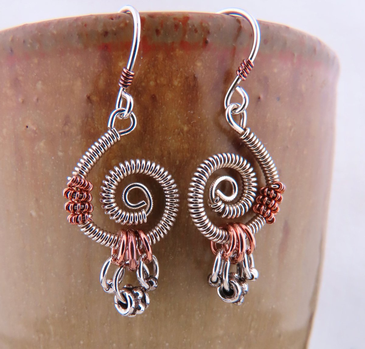 Recently listed in my #etsy shop: Mixed Metals Copper and Silver Wire Wrapped Earrings etsy.me/3C6Waxm #silvercopper #christmasgift #bohohippie #coiledwirejewelry freeformearrings #artisanwirejewelry #coppersilverearrings #giftfordaughter