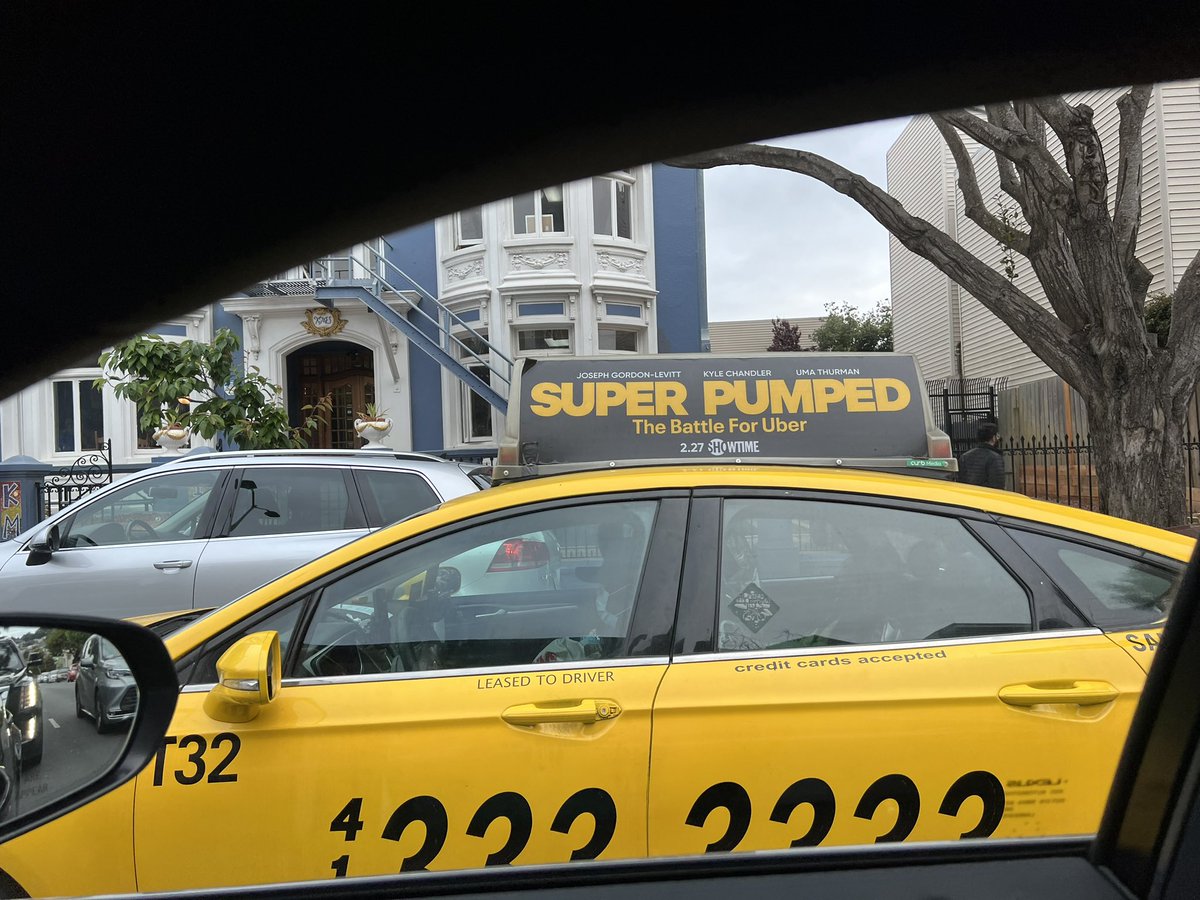 New movie about <a href="/Uber/">Uber</a> being advertised on top of a yellow taxi.