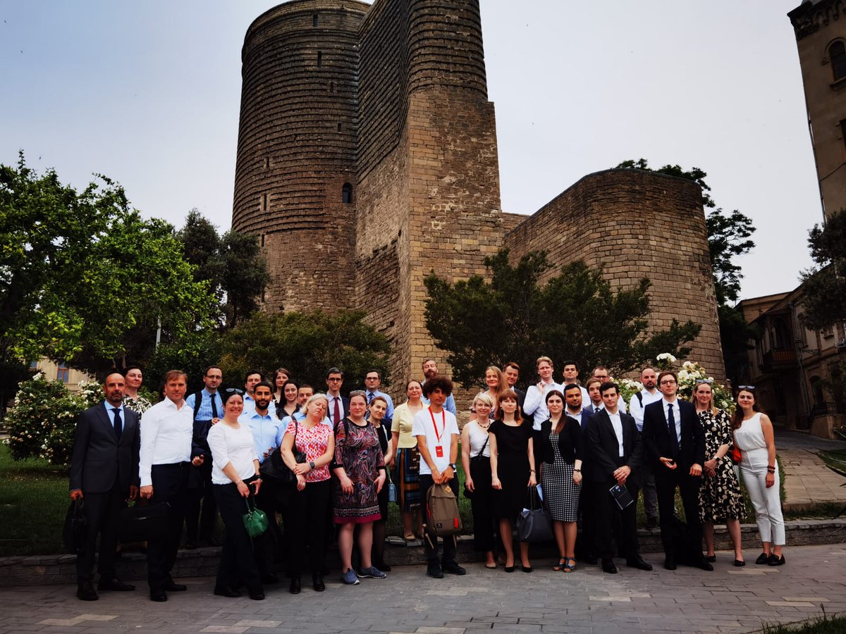 AZMissionEU's tweet photo. #COEST Delegates' guided tour in #Baku today began with a heartfelt visit to Martyr's Alley, honoring 🇦🇿 's fallen heroes, proceeded to the rich artistic tradition at the Carpet Museum, and concluded in beautiful historical Old City. A day embodying the spirit of Azerbaijan. #MaidenTower 
#OldCityBaku