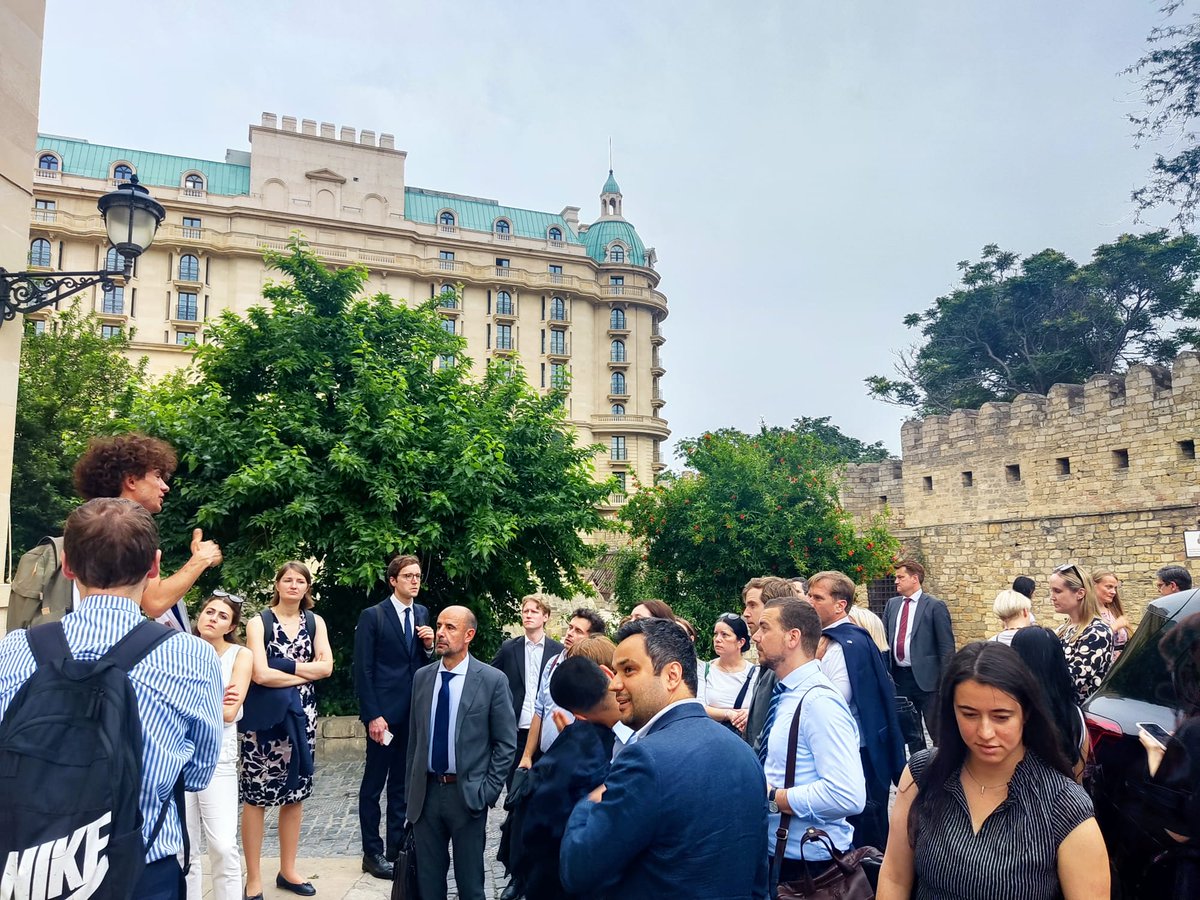 AZMissionEU's tweet photo. #COEST Delegates' guided tour in #Baku today began with a heartfelt visit to Martyr's Alley, honoring 🇦🇿 's fallen heroes, proceeded to the rich artistic tradition at the Carpet Museum, and concluded in beautiful historical Old City. A day embodying the spirit of Azerbaijan. #MaidenTower 
#OldCityBaku