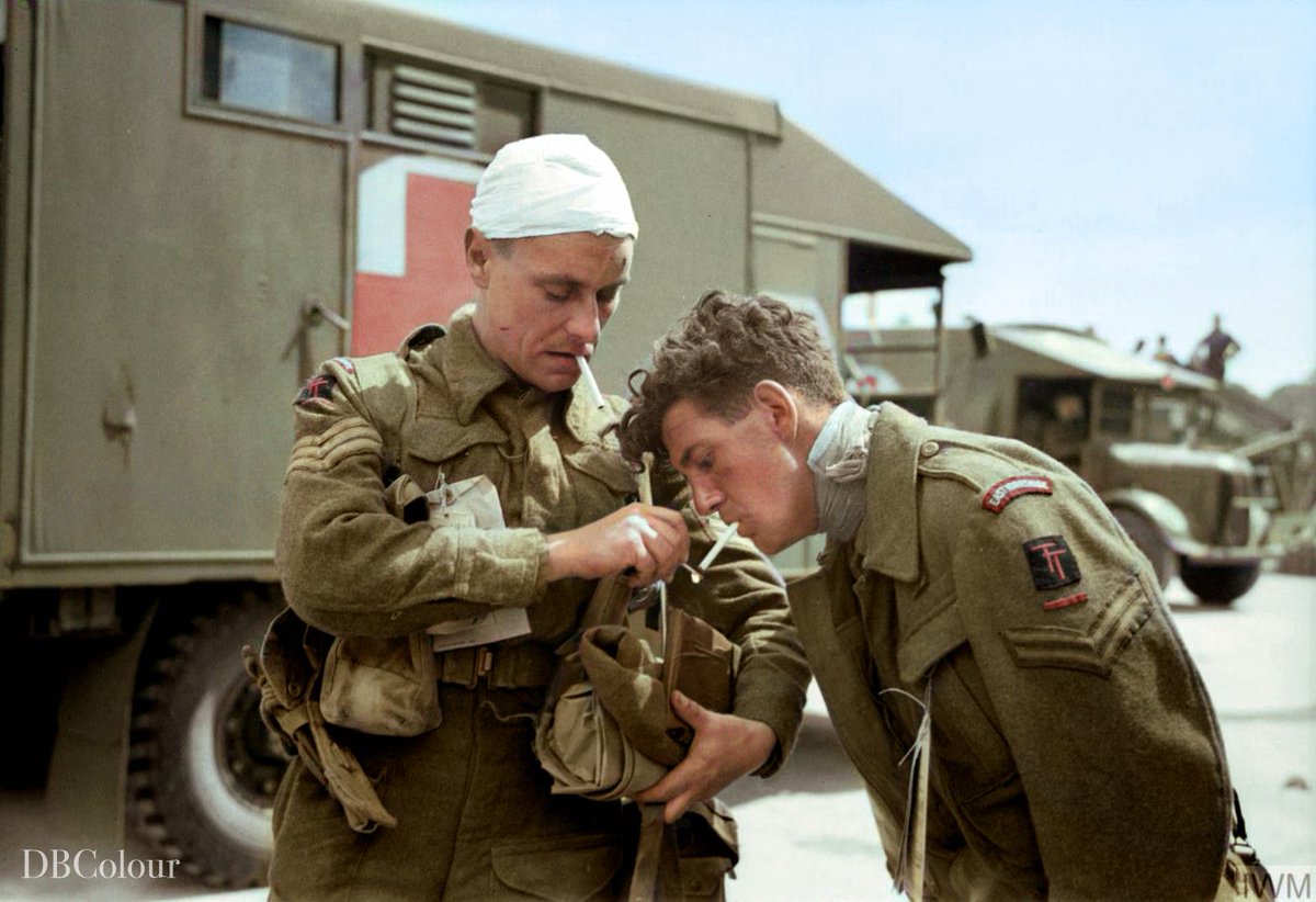 7 June 1944
East Yorks Regt., 50th (Northumbrian) Infantry Division men, Sergeant G A Maynard lighting a cigarette for Corporal Sidney Polls on arrival at Gosport, Hampshire on their return from the Normandy beaches.   © IWM H 39199