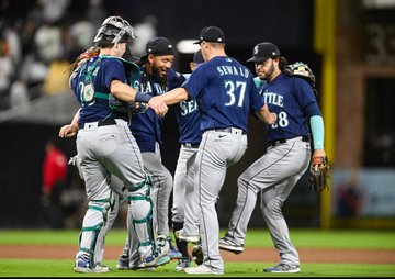 Mariners players dance in a circle after their win in San Diego tonight. 