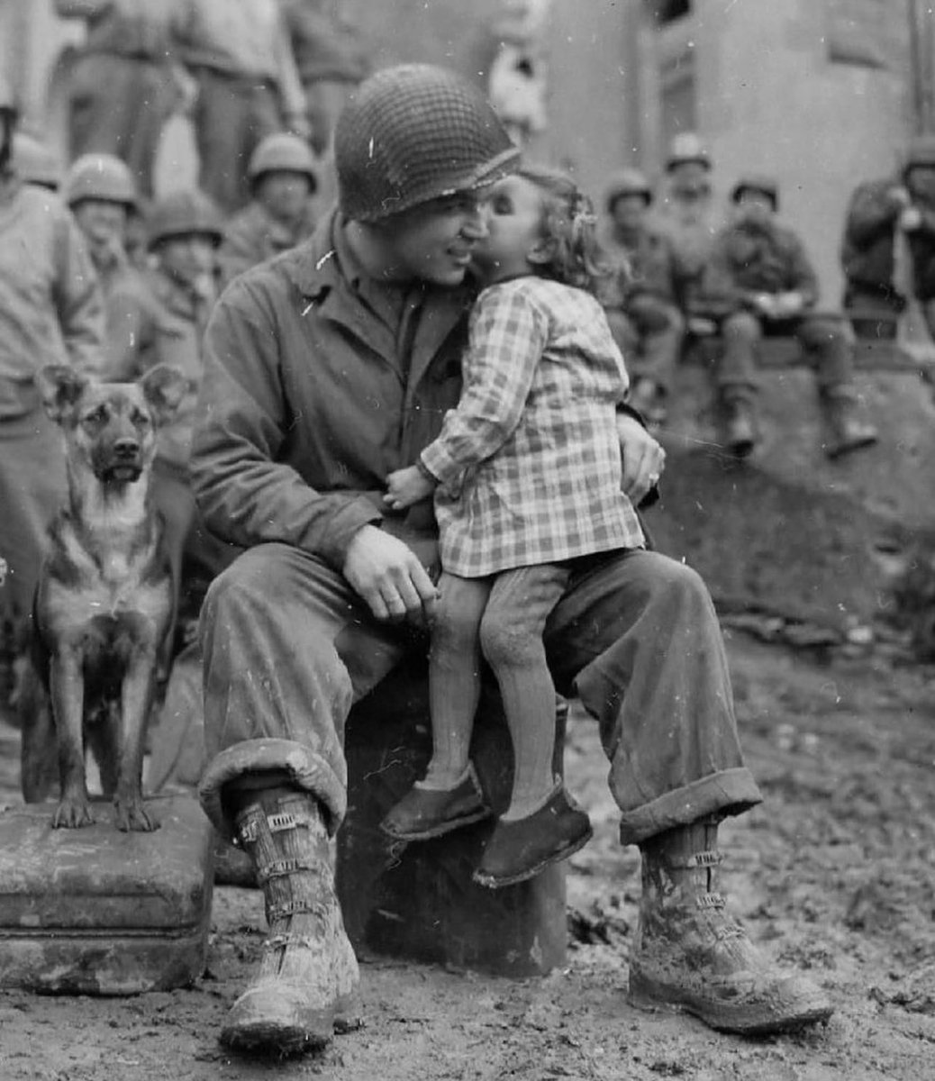 Sergeant Elvin Harley (Kalamazoo, Michigan) being kissed by a little French girl. After the liberation of France from Nazi rule, this proud member of the 3rd Armored Division survived the rest of the war and returned to Michigan.