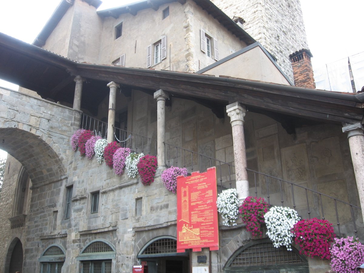 The covered staircase of the Palazzo della Ragione, bedecked in flowers.