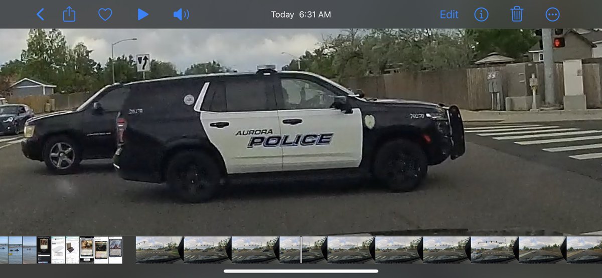 cato1978's tweet photo. @AuroraPD Not sure this officer’s phone could have been any more in their face while rolling through the intersection. https://t.co/IHnRY8hs79