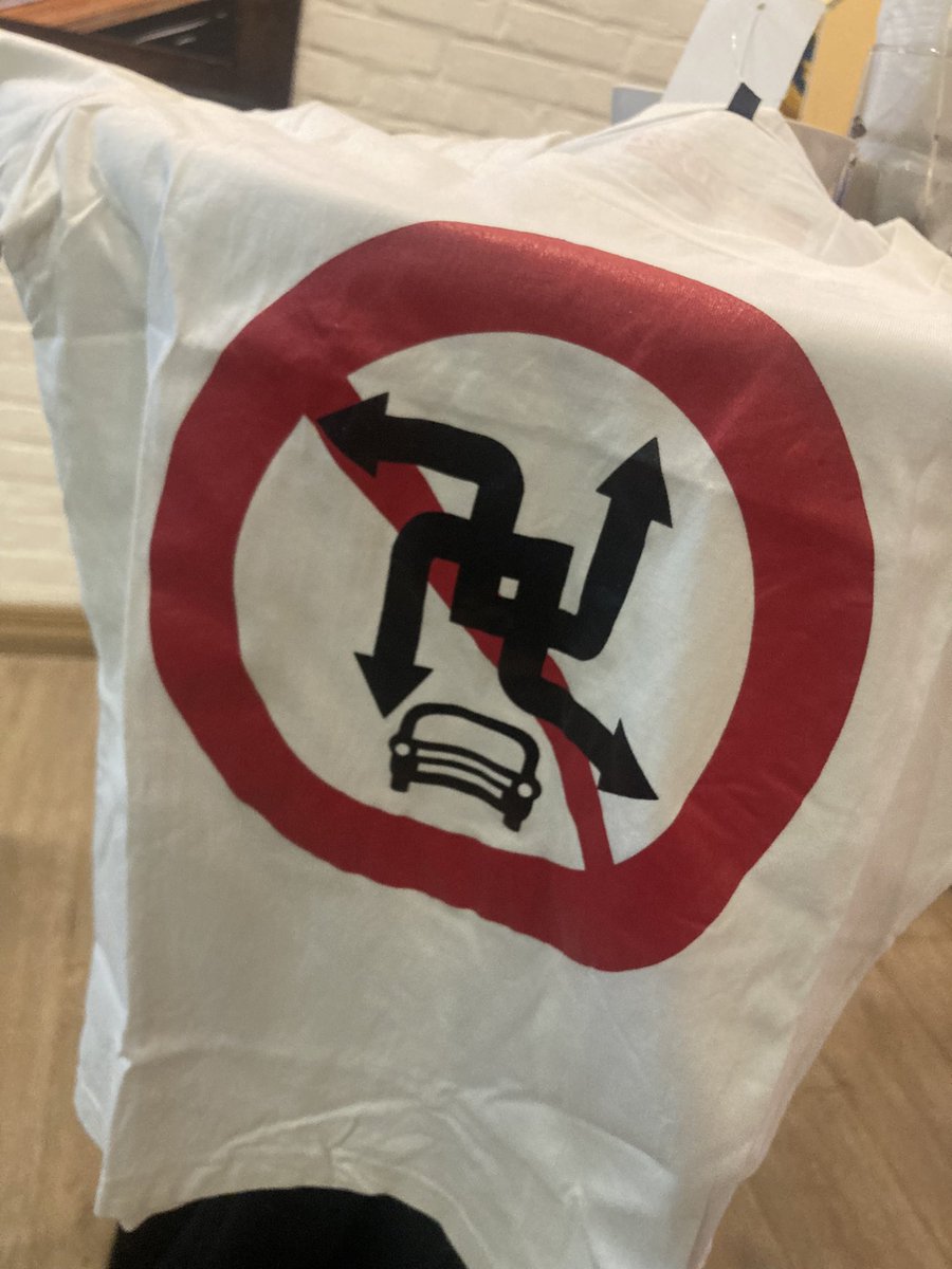 RayVersionTwo's tweet photo. I’m at a charity do and someone just won this t-shirt. This is basically a swastika, right…? 😬 https://t.co/sPs0eGtEwM