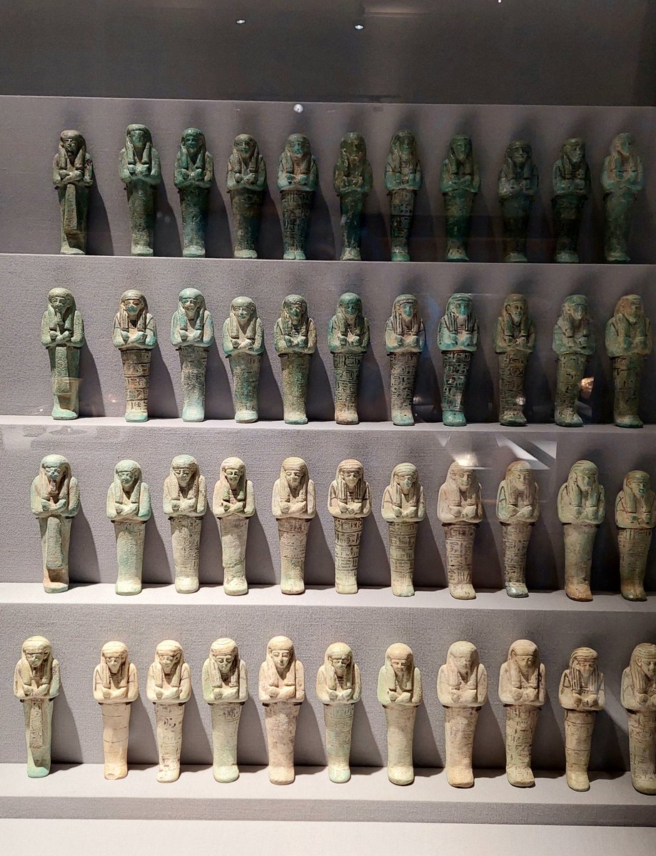 Faience and bronze Shabtis of King Psusennes I , 21st Dynasty.
1-Faience shabtis: Overseers with braided beards, a column mentions Osiris- King Psusennes is on the front of their loin cloths. The beardless servants hold hoes.
The Egyptian Museum,Cairo 
Photo taken by me 📸