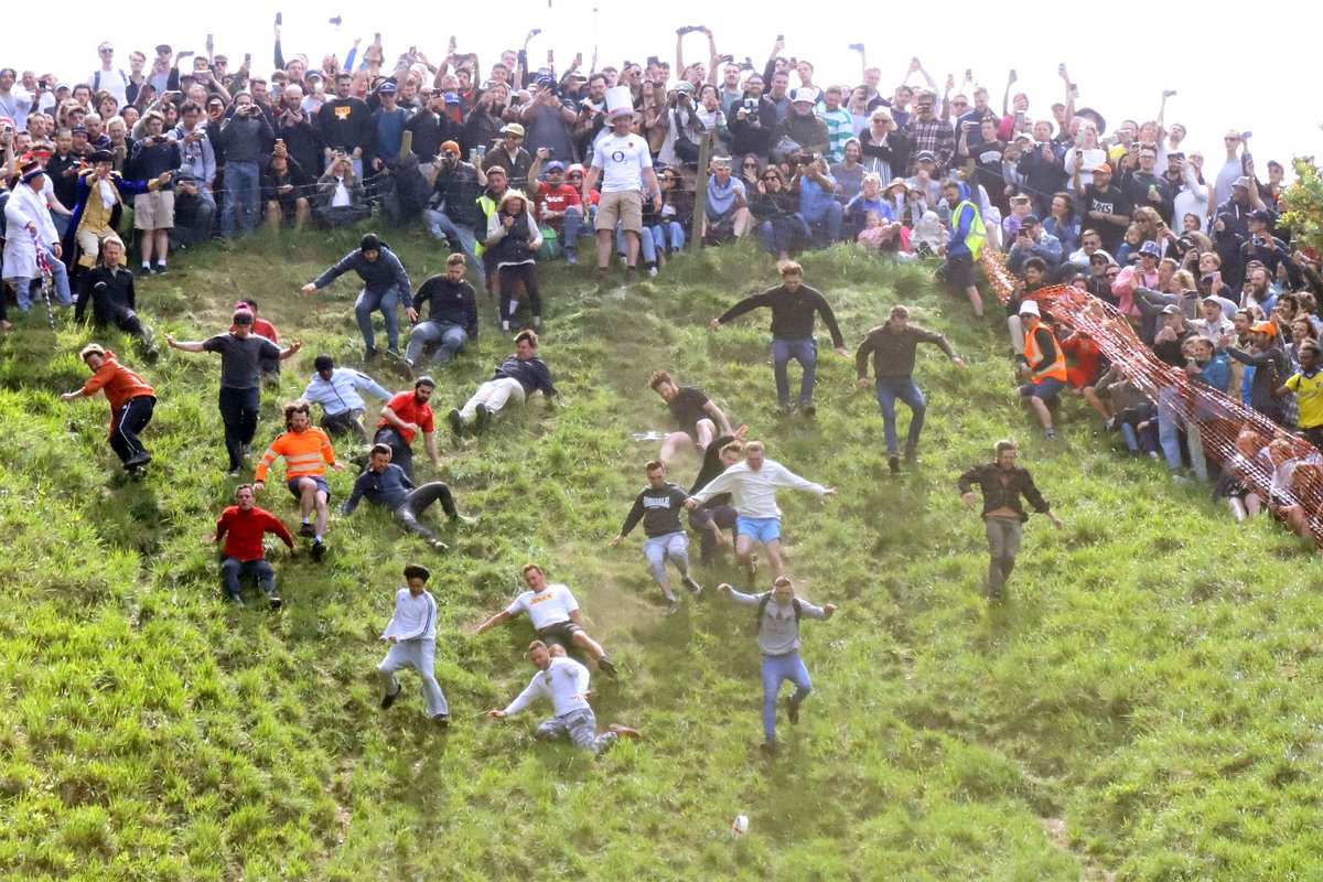 Cheese Rolling at Coopers Hill in Gloucestershire. Twenty competitors chase a wheel of cheese down a very steep hill. 29-May-2023. Story & MorePics: bryan-jones.com/2023-coopers-h… #cheese #CheeseRolling #CoopersHill #race #tradition #Brockworth #Gloucestershire #England #extremesport