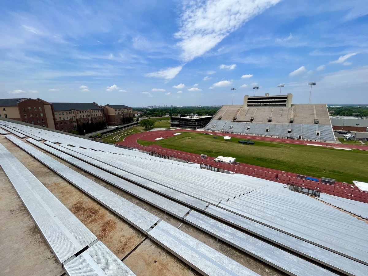 Last view from the top of the east side of Cessna Stadium. Construction workers putting up fencing on the track to begin demolition.