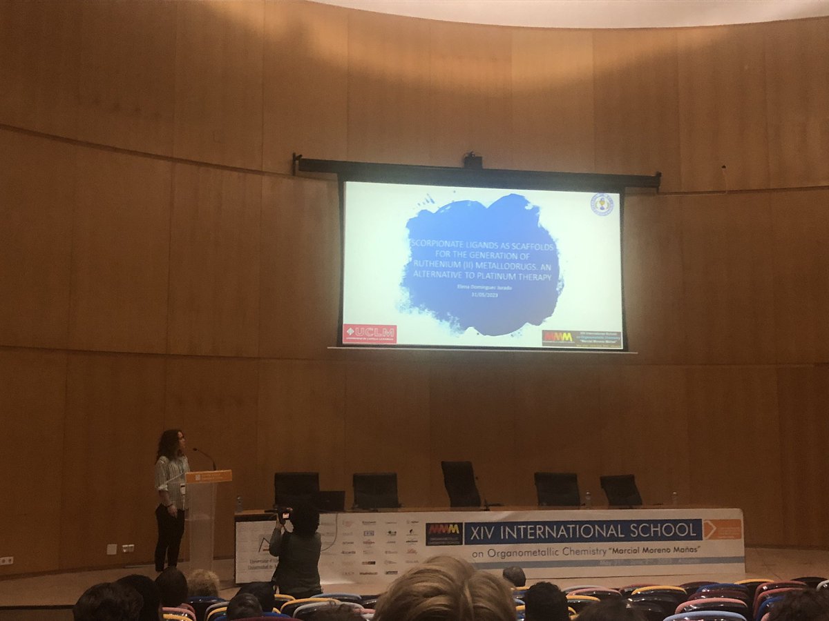 On the stage, Elena Domínguez presenting her work on the scorpionate ruthenium complexes as antitumoral agents!! <a href="/helen_DJ/">Elena</a> @ISOC_MMM_2023