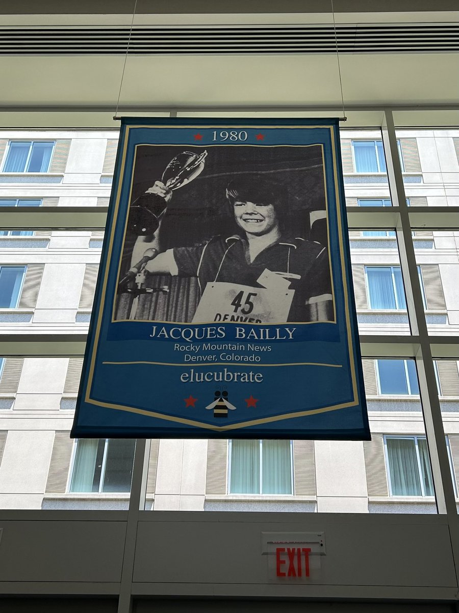 Did you know Dr. Bailly, the pronouncer at <a href="/ScrippsBee/">Scripps National Spelling Bee</a>, was once a winner himself? He won with ‘elucubrate’ back in 1980. Check out his winner flag! #spellingbee