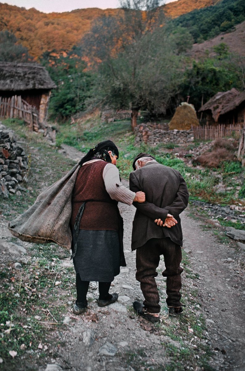 Elderly couple heading home after working in their corn fields. Gostivar, Macedonia, 1989.