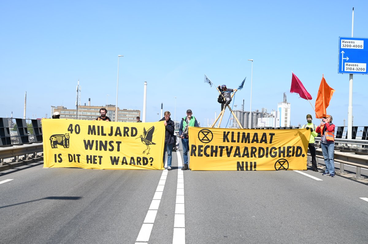 NLRebellion's tweet photo. We bezetten momenteel de toegangsweg naar #ShellPernis, de grootste #olieraffinaderij van Europa, in #Rotterdam. De actie blokkeert de aanvoer van fossiele brandstoffen van en naar de Pernis-raffinaderij en verstoort het productieproces van Shell. [1/2] https://t.co/AbfY5HgiDc