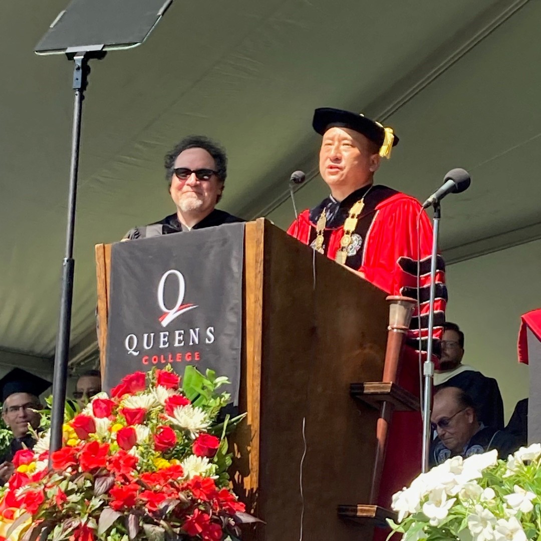 QC_News's tweet photo. Queens College President @frankhwu welcomes writer, director, producer, executive producer, and alumnus @Jon_Favreau to the podium to be hooded as the recipient of an honorary doctorate of fine arts. Warmest congratulations! #BabyYoda would be proud; QC certainly is! 😉 https://t.co/EQ9lczjua4