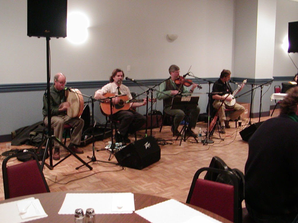 Left to right: Andy Weiner (bodhran), Paul Burton (guitar), Adam Sweet (fiddle), John Rough (banjo).  St Patrick's Day party in Northampton, MA
