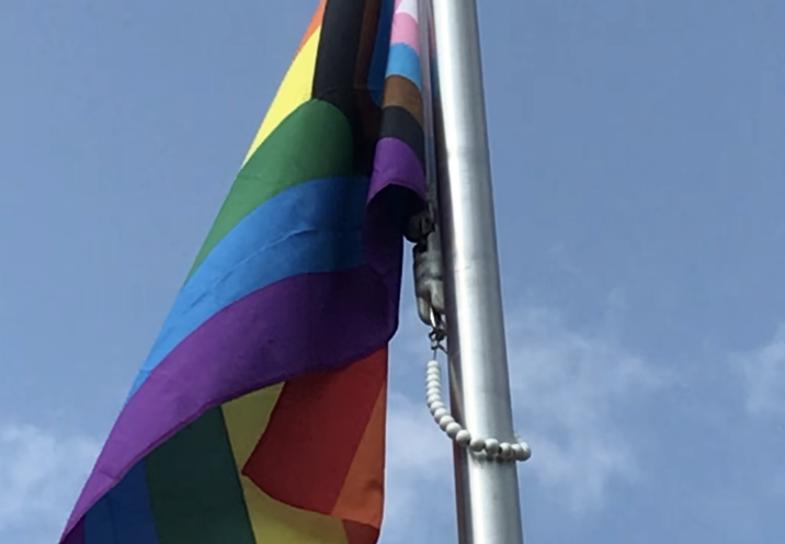 Lourdes raises the Progress flag in front of the school to launch Pride month. We are enriched by the diversity of love in this community!