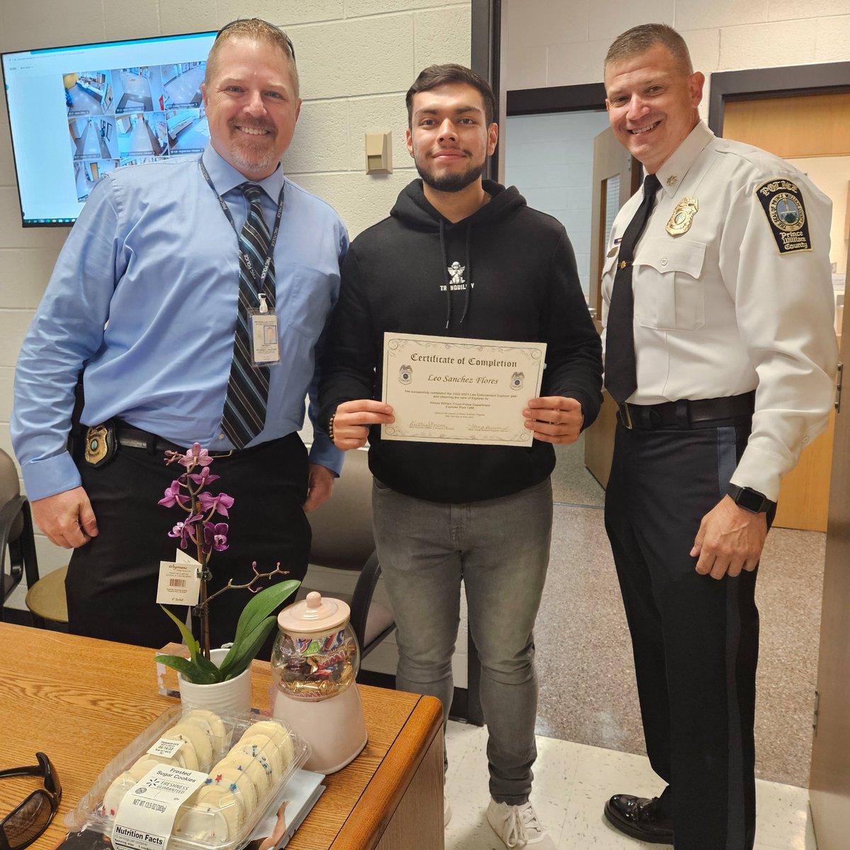 EXPLORER #GRADUATION: LTC Phelps (R) & SGT Grantham (L) recently visited Freedom High School to present senior Leonel Sanchez-Flores (middle) his graduation certificate as a Police #Explorer. Leonel has been a part of the program for 4 years & we wish him all the best! #PWCPD