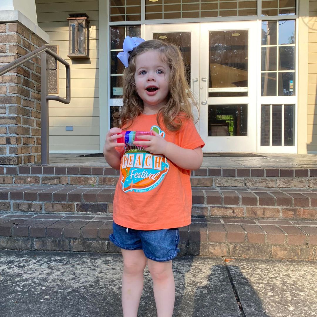 Don't forget the littles! We have kid's shirts available now at the Ruston-Lincoln Convention &amp; Visitors Bureau - sizes 12m-YXL. 🍑🧡 Check out our merch tent on Saturday for Peach Fest posters, postcards, stickers, and t-shirts!