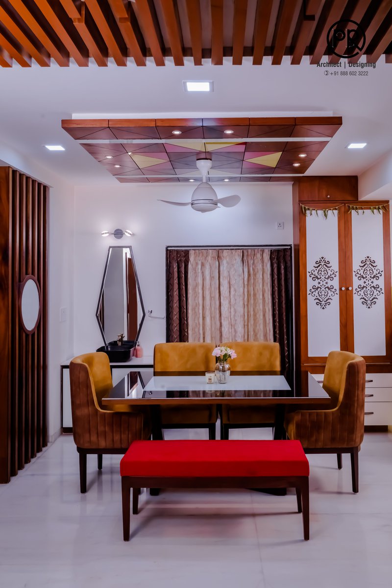 Experience a dining area that exudes a vibrant ambiance, as a brightly colored ceiling adds a pop of energy to the space, while the Pooja unit nestled on the side imparts a sense of sacredness, seamlessly blending style and spirituality.  #diningarea #diningtable #poojaunit