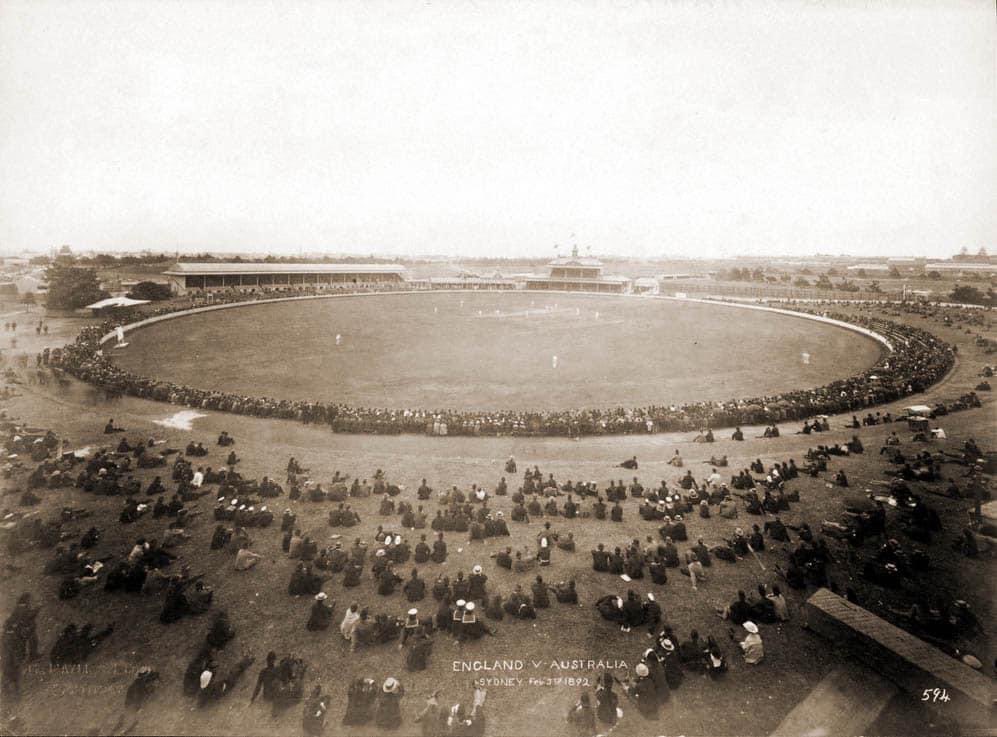This is a shot high up of the <a href="/scg/">Sydney Cricket Ground</a> (Association Ground) during the 2nd Test match of the English tour of 1891-92, which was led by the ‘amateur’ WG Grace. He was paid the exorbitant fee of £3k to lead the tour. 

Australia won this match by 72 runs, thanks to Giffen’s 10 wickets.