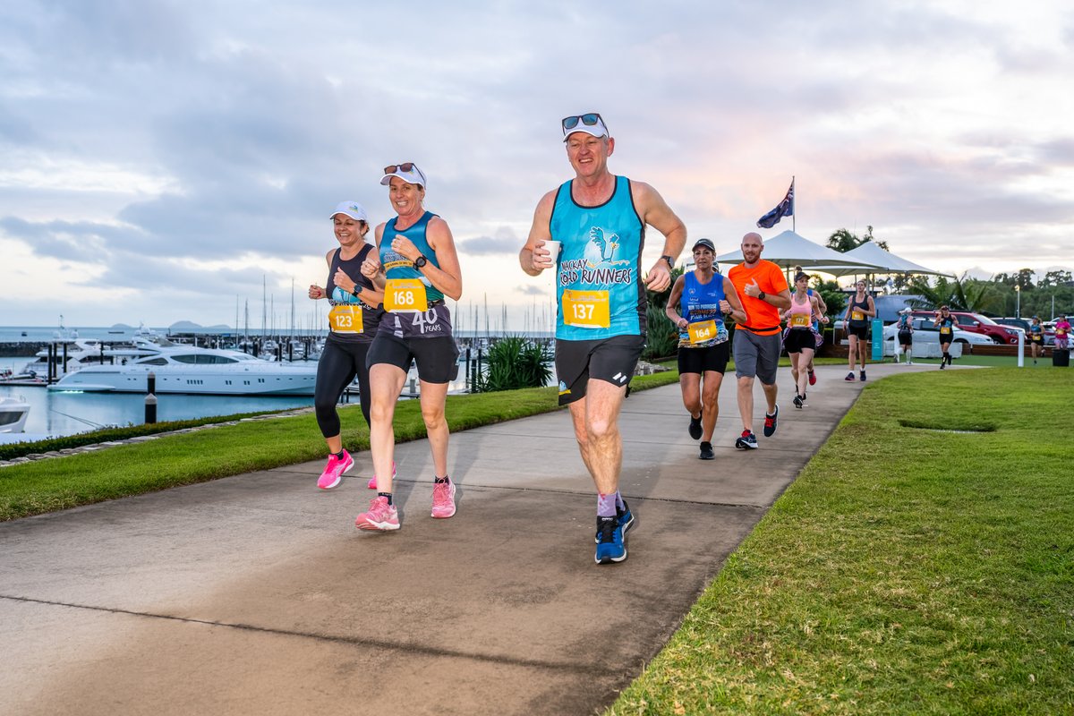 The President's (Mackay Road Runners) Bus travelling through Coral Sea Marina and Port of Airlie. To catch the bus on 15/16 July register at runairlie.com.au #ABMF23 #marathon #halfmarathon #10k #5k #2k #1k #1mile #kids #corporate #runairlie