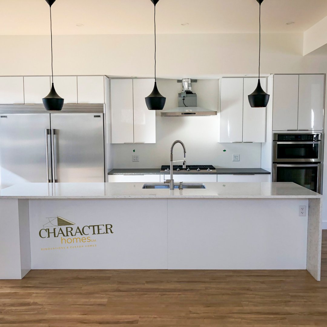This kitchen reno project turned out beautifully! The homeowners wanted a bright & spacious space to could cook, eat & entertain. They chose white walls, large windows & a stunning quartz island. What do you think of this gorgeous new kitchen #HomeRenos #HomeBuilder #CustomHomes