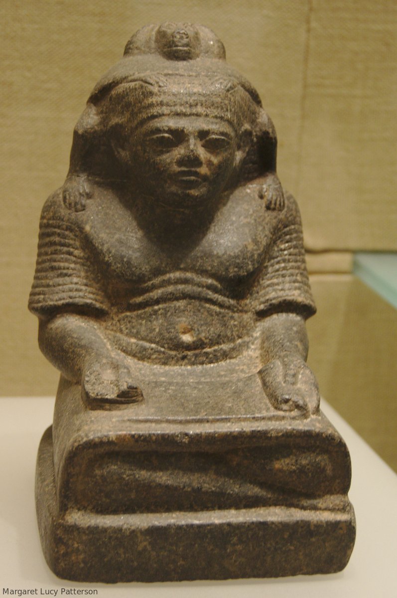 This little piece, only 22cm tall, was made a bit over 3000 years ago during the later New Kingdom. The man it represents is a scribe, shown sitting cross legged with his papyrus roll open on his lap. He’s quite chubby, indicating that he’s high status enough to be well fed.
