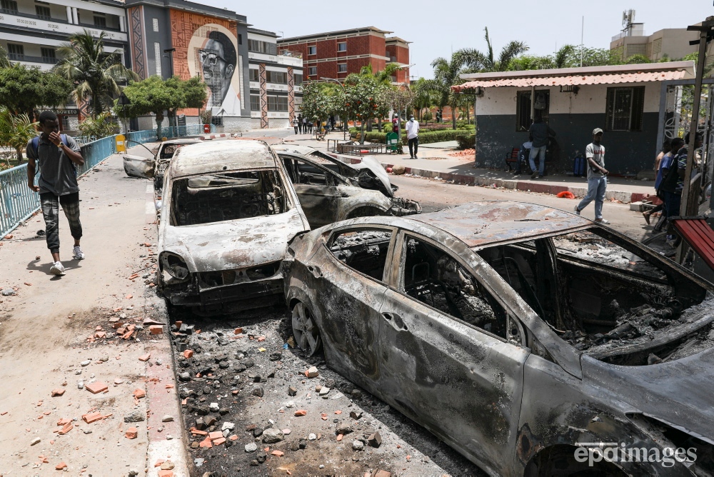 People walk past the torched car wreckages inside Cheikh Anta Diop University following clashes after the conviction on 01 June of opposition leader Ousmane Sonko on charges of corruption, in Dakar, Senegal, 02 June 2023.

📸 EPA / Jerome Favre

#epaimages #senegal