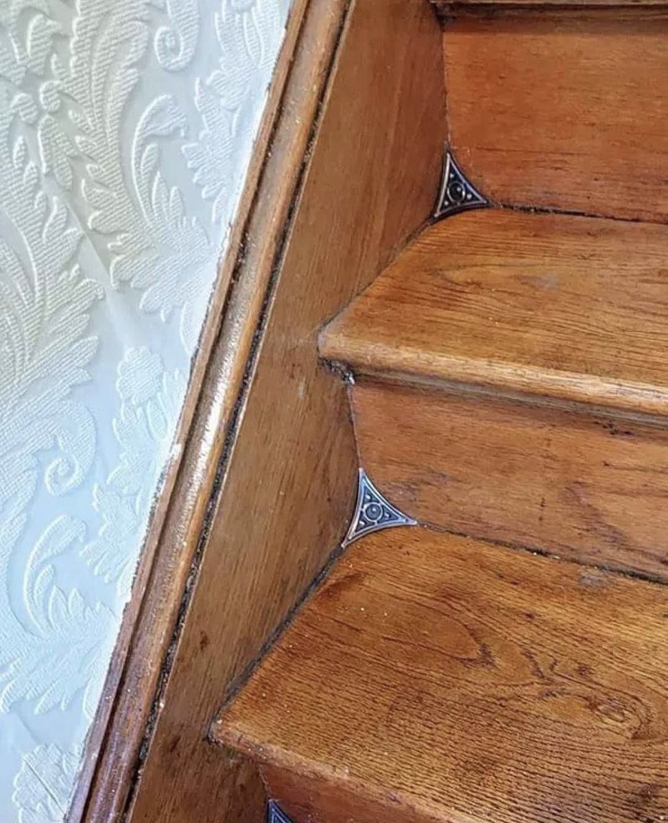 Stair dust corners introduced at the end of the 19th century to make sweeping easier. They keep dust from accumulating in the corners.