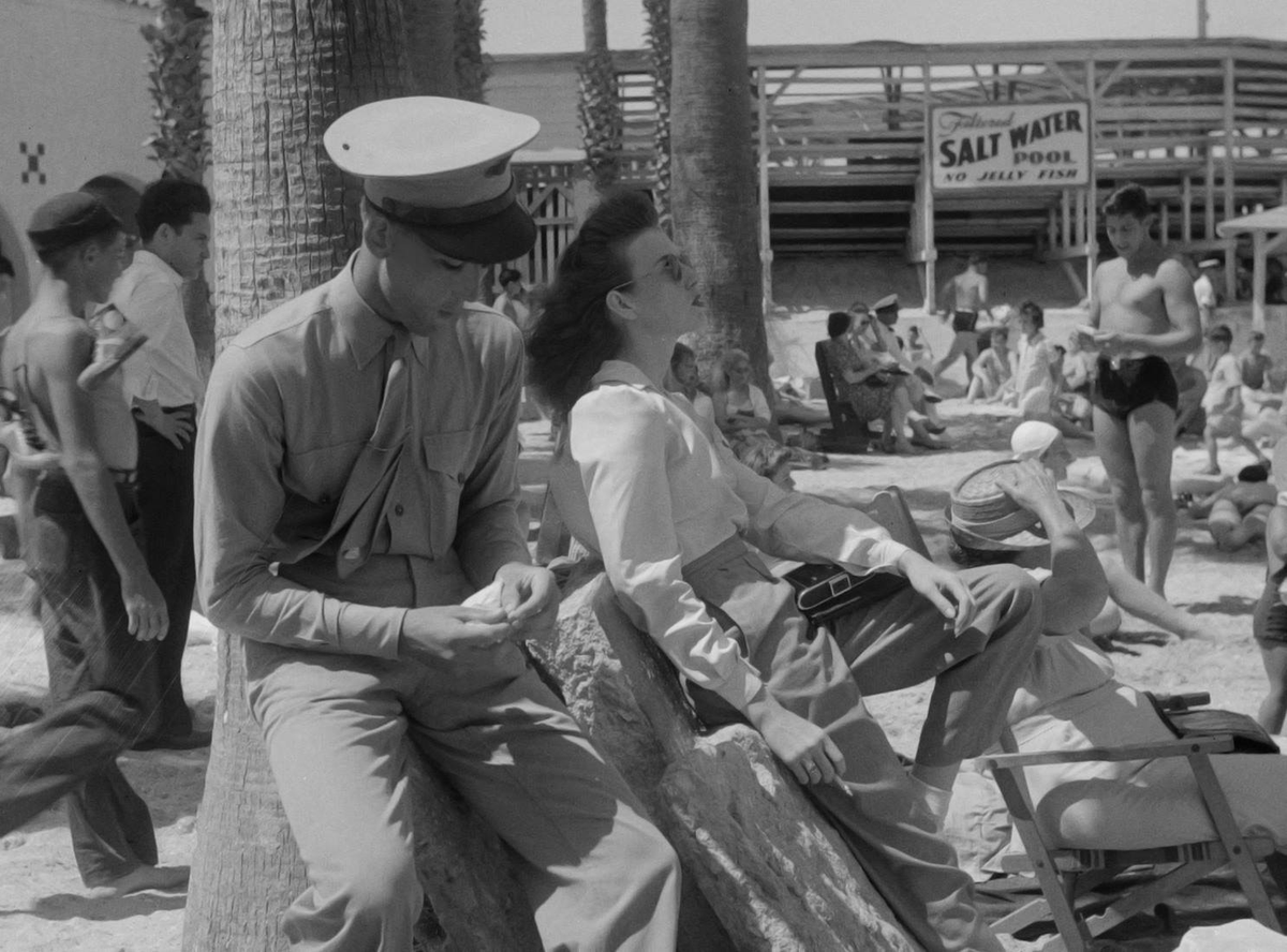 TracesofTexas's tweet photo. Man in uniform rolling a cigarette in Corpus Christi as his girlfriend coolly smokes while taking in the sun, 1943. The sign reads "Filtered Salt Water Pool    No Jellyfish."  That's a good thing!

This remarkable photo taken by John Vachon. https://t.co/xAP8cgF6br