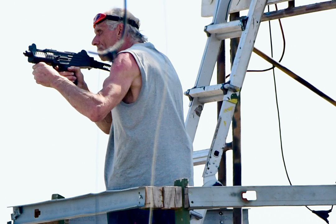 This man displayed a Nazi flag, is playing eye of the tiger over loudspeakers, and is threatening to kill Chicago police officers and the mayor