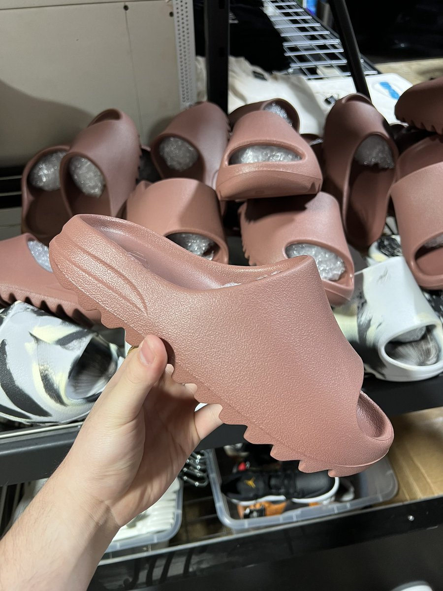 yeezy earth brown slides on feet