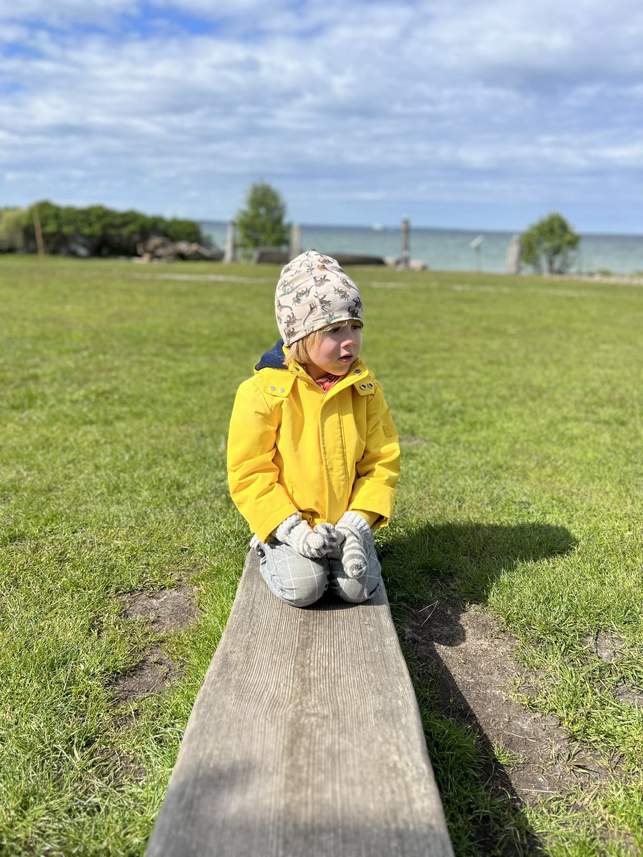 Estonian summer. Child wears winter clothes and gloves.