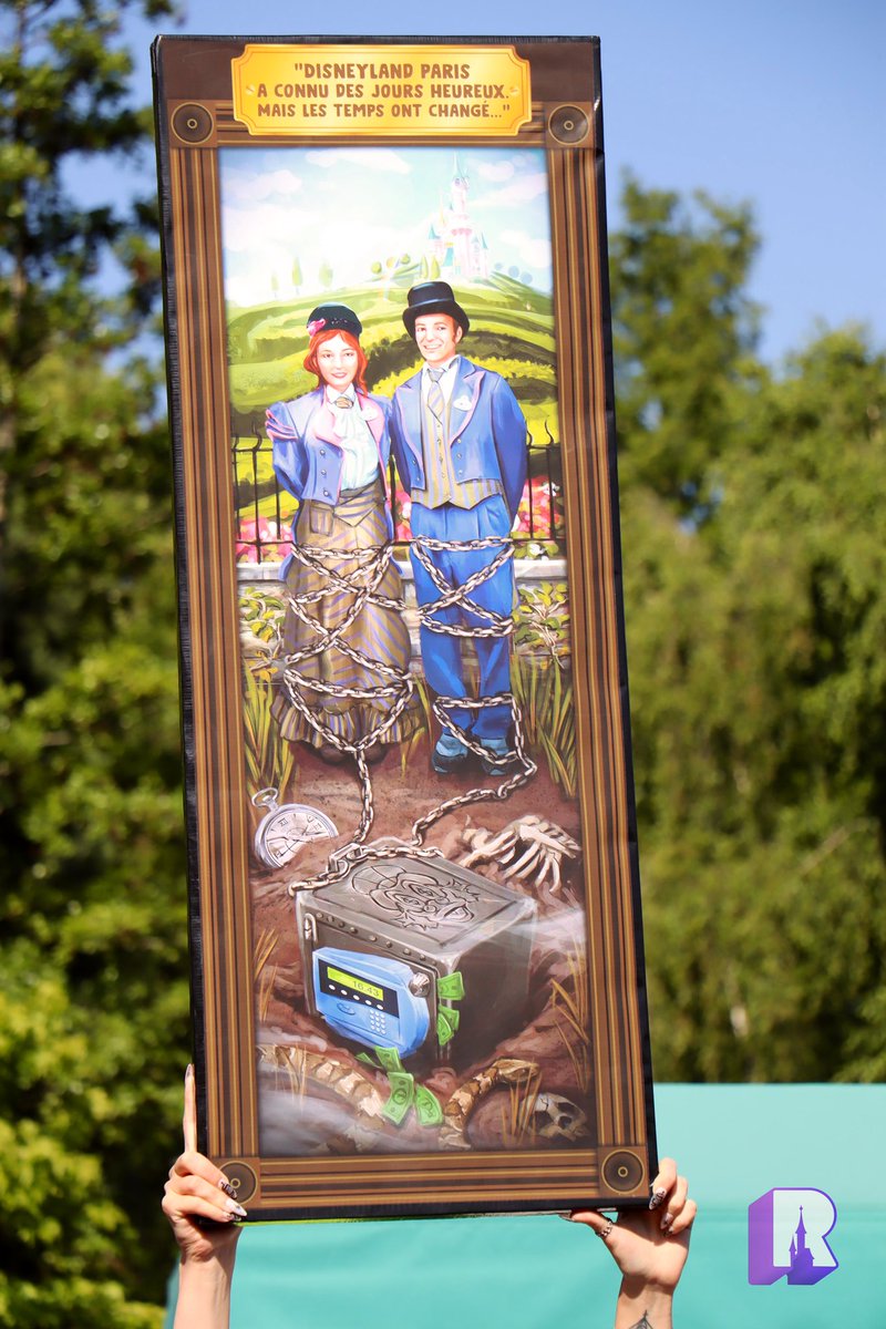 DLPReport's tweet photo. A fantastic Phantom Manor inspired placard for today’s Disneyland Paris Cast Member strike! https://t.co/CxUK2orPA0