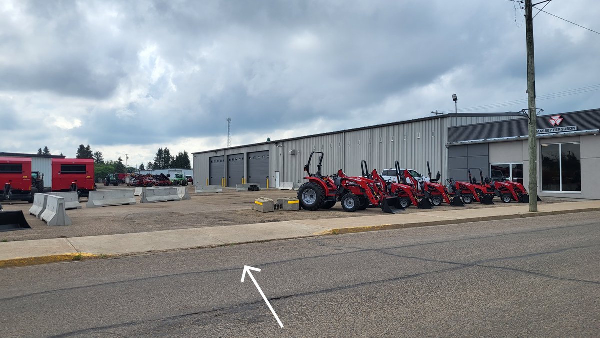 ATTENTION: 
Parking at the new building is located on the West side Infront of the building along the street
OR
There is a customer parking lot on the North side of the building, The approach is located between the Massey Ferguson Tractors (as directed by the arrow in the photo)