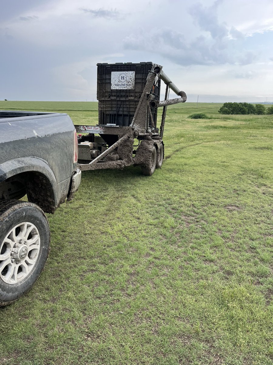 Tim15167195's tweet photo. Nothing says commitment more than getting caught in a downpour pulling a seed tender down a 2 mile stretch of dirt road https://t.co/iqcKUOF0Te