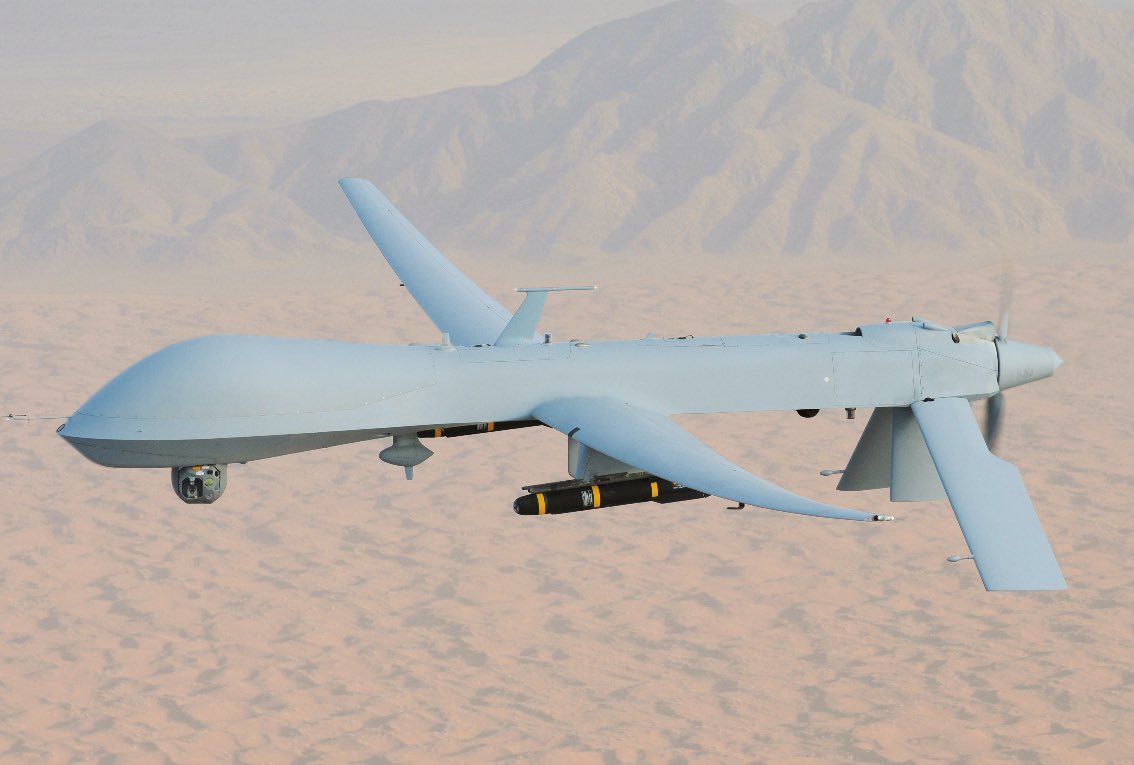 1/10 The nature of war has shaped our world, from violence to power struggles. The author explores the intertwining of US drone warfare and the military-industrial complex, shedding light on the political economy behind it. Image by (General Atomics MQ-1 Predator by Wikipedia)