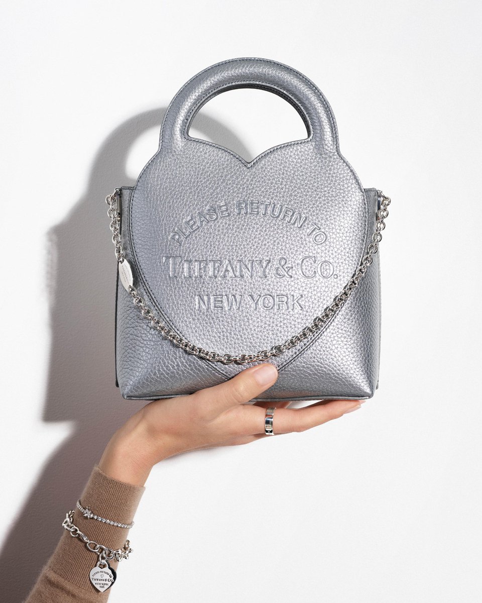 Our Return to Tiffany® tote in silver leather is an homage to the House’s iconic jewelry collection. Embossed with our signature heart motif and designed with a detachable strap, it’s as practical as it is playful. Discover more: bit.ly/3C7I8ff #ReturnToTiffany
