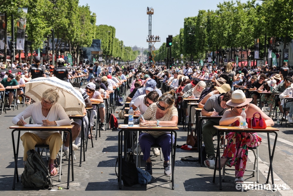 Participants write during 'The World's Largest Dictation' on the Champs Elysees in Paris, France, 04 June 2023. The Champs-Elysees Committee expected around 1,700 people to take up the challenge. 📷️ EPA / Teresa Suarez

#Paris #ChampsElysees #dictation #worldrecord #epaimages