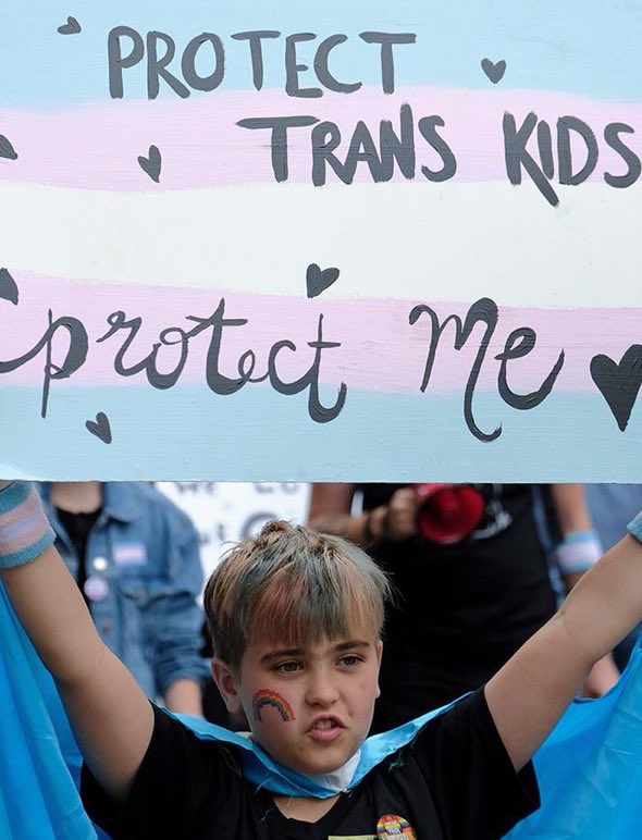 This sign should say “PROTECT TRANS KIDS from their parents who exploit them for woke credit.”