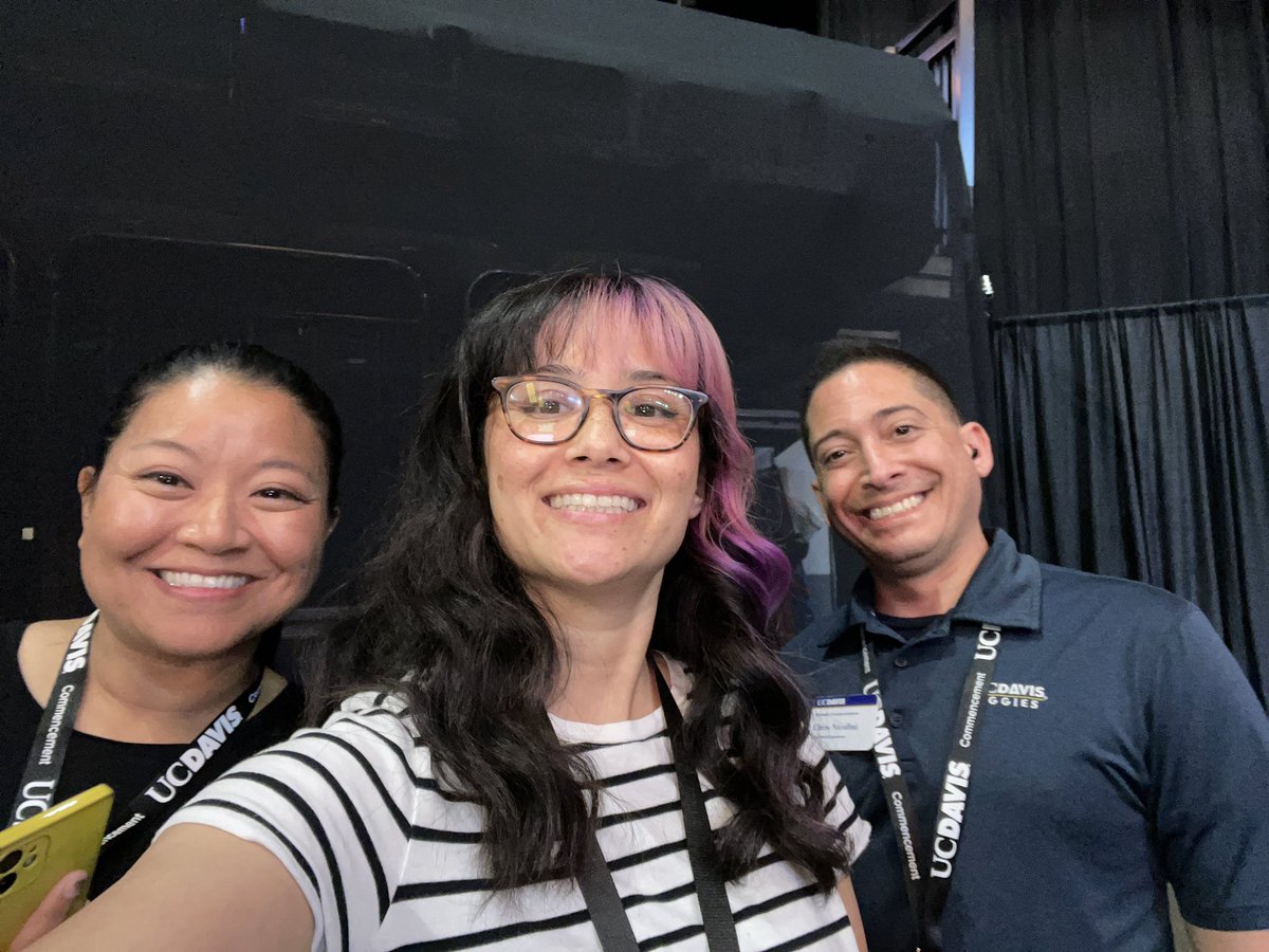 karlafung's tweet photo. .@ucdavis Team Social out here running around capturing those incredible #UCDavisGrad moments!

Image description: Karla, TC and Chris smiling at the camera on the commencement stage sidelines. https://t.co/L8fjOR5edU