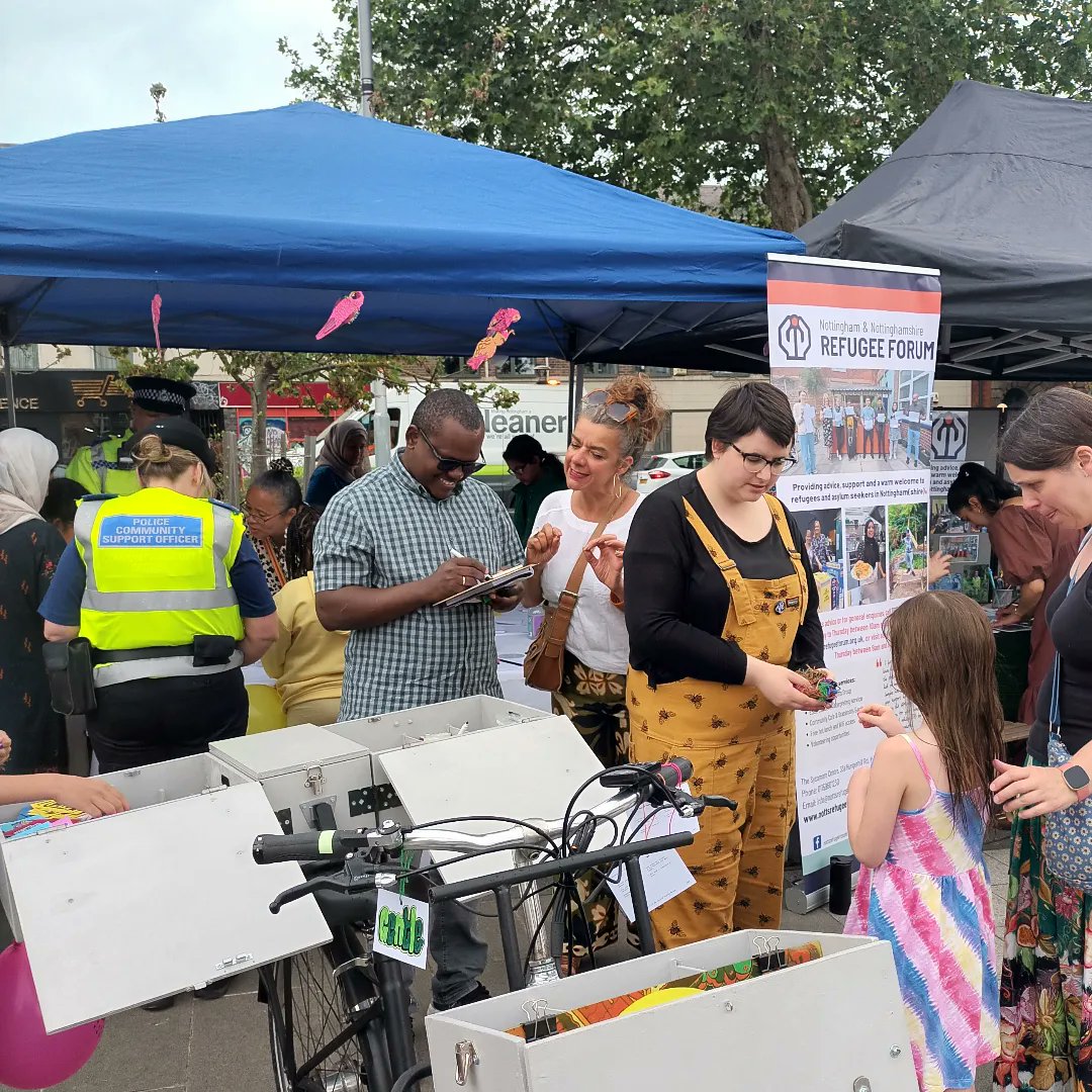 Beautiful show of togetherness just when it was neeeded. Turning <a href="/JusticeMuseum/">National Justice Museum</a> inside out, covering museum steps with powerful words of welcome &amp; love, crafting togetherness tags for museum bicycle, making spinning tops of kindness @SneintonMarket for #RefugeeWeek launch /1