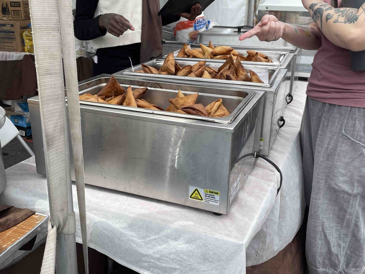 UTRefugeeServe's tweet photo. Feeling hungry? Check out the great food from the Spice Kitchen Incubator  program. The food booths are run by refugees who are currently in the program or graduated from the program. You can try one place or get a little bit from multiple places. #WorldRefugeeDay #Food https://t.co/2ku0xUHHH2