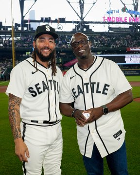 J.P. Crawford and Mike Cameron pose and smile together on the field, both wearing Seattle Steelheads jerseys. 
