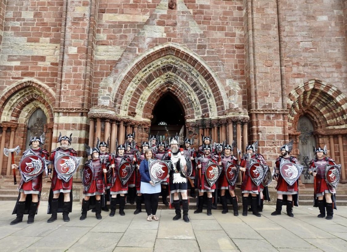 2023 jarl squad presenting a shield to @NLFerries outside the Kirkwall cathedral as a thank you for their support of up helly aa