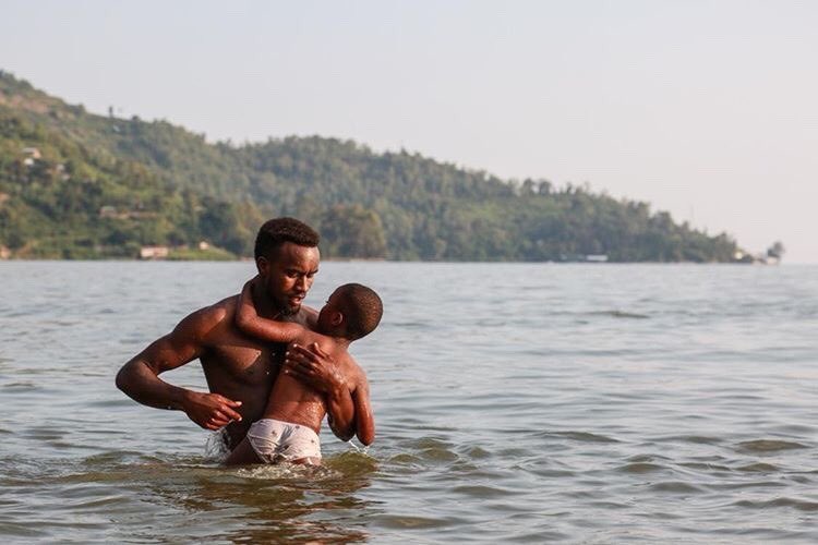 A father teaches his son to swim at Lake Kivu. 

Western Province, Rwanda - David A. Wilson