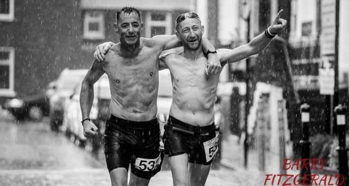James Sheehan and Fozzy Forristal cross the finish line together in a biblical deluge to be joint winners of yesterday's Tralee 100K Ultra Marathon.