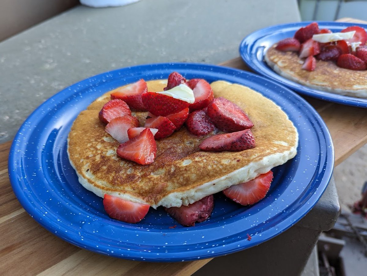 How about campfire pancakes with strawberries and melted butter?